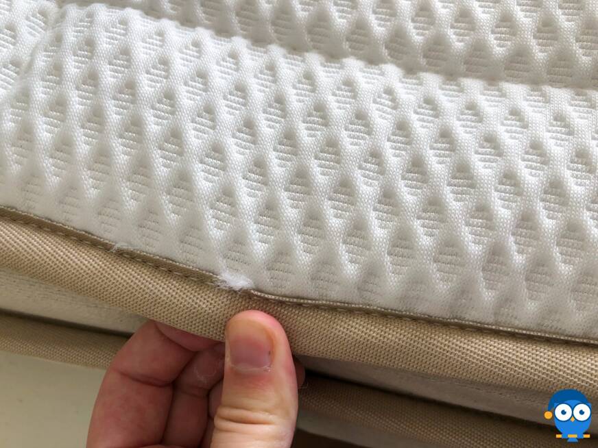 Close up of loose threads on Dreamcloud mattress